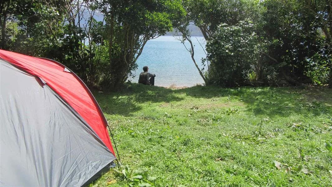 Person and tent at Blumine campsite.