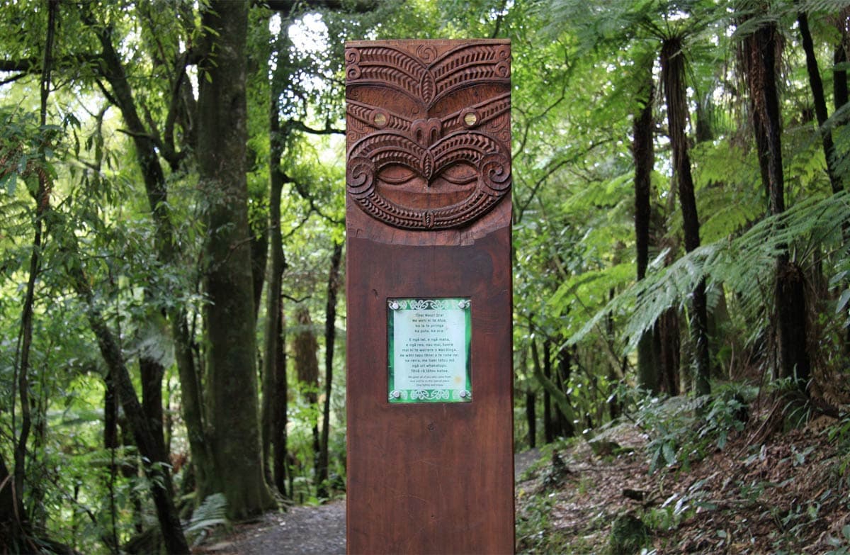 Maori pou (carved pillar) greets visitors at the start of the Waireinga or Bridal Veil Falls walk.