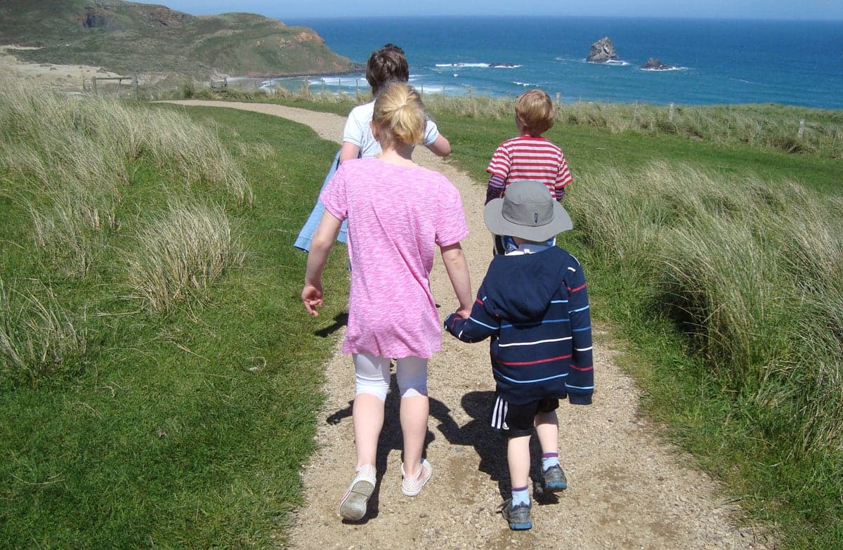 Children walking down to Sandfly Bay.