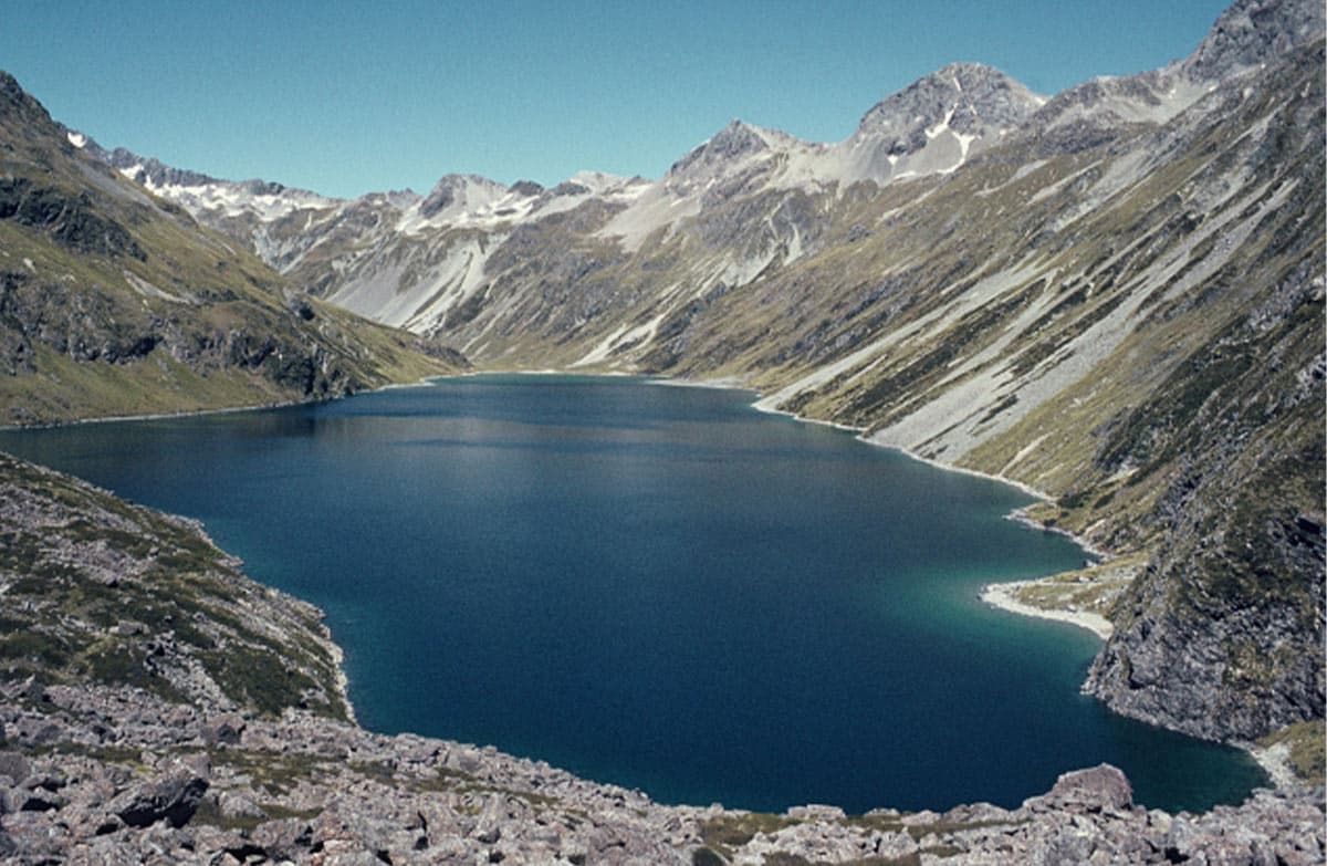 A huge blue lake set in the mountains.