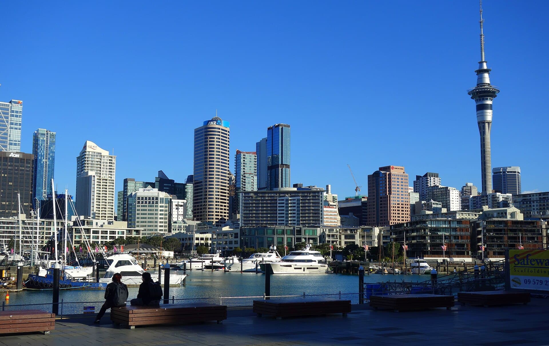 Auckland waterfront buildings and the Sky Tower above moored boats.