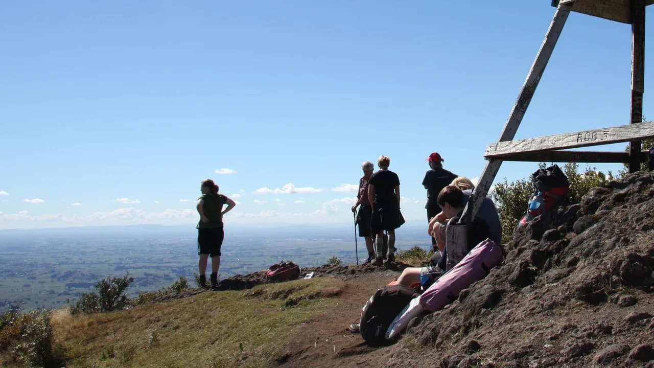 Admiring the views from Ruapane Trig: Visitors beside Ruapane trig.
