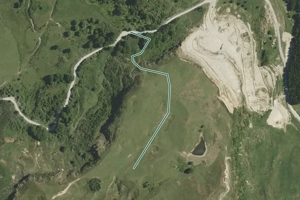Historical aerial overview of the mapped Mangaone Caves Track route, with an indicative DOC route overlay.