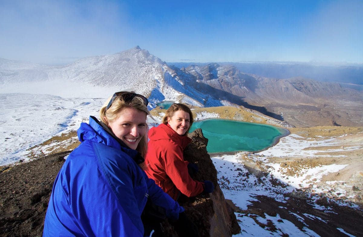 Women by emerald lake on Tongariro Northern Circuit.