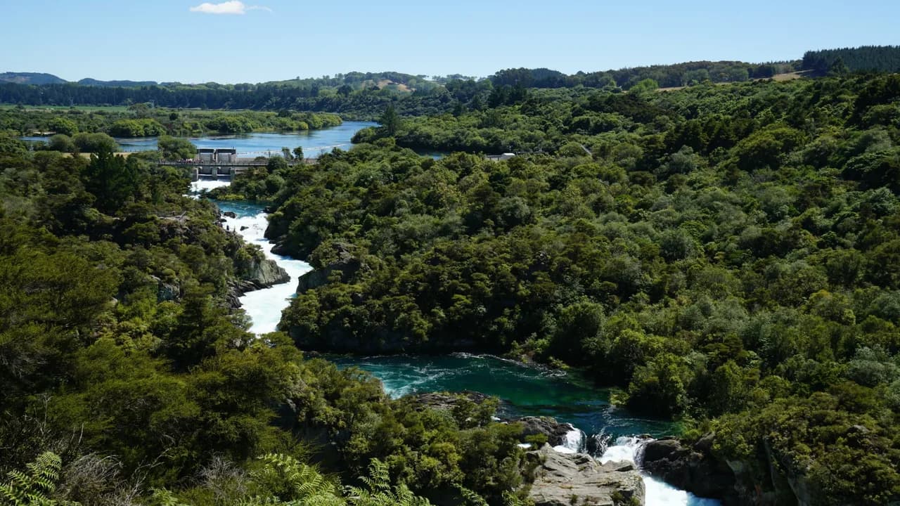Visitors watch from the bridge and the first lookout point as the dam gates open and fill the rapids: River rapids below the viewing area.